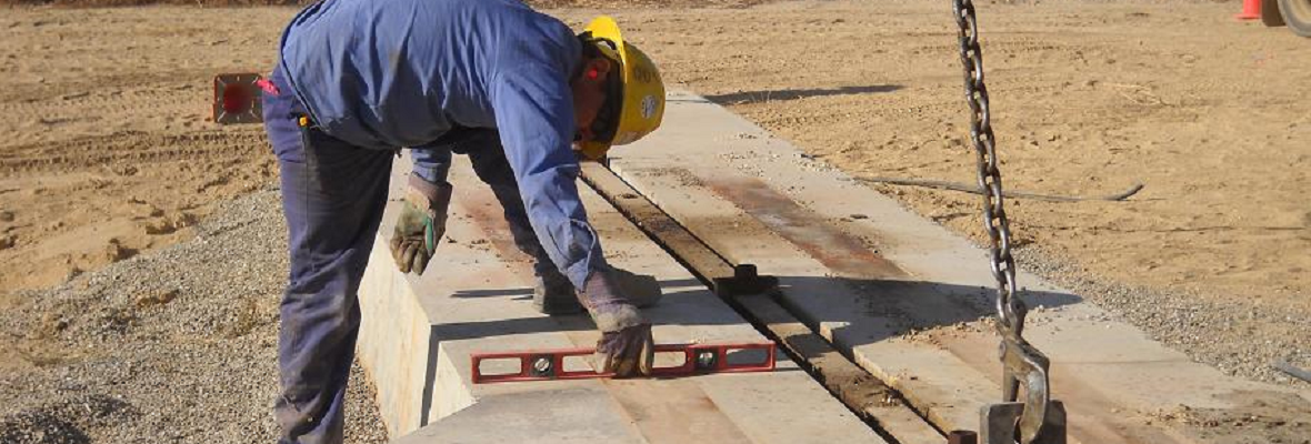 ULT field technician levelling a pumping unit foundation